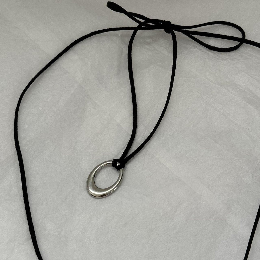 Chunky silver circular pendant corded necklace