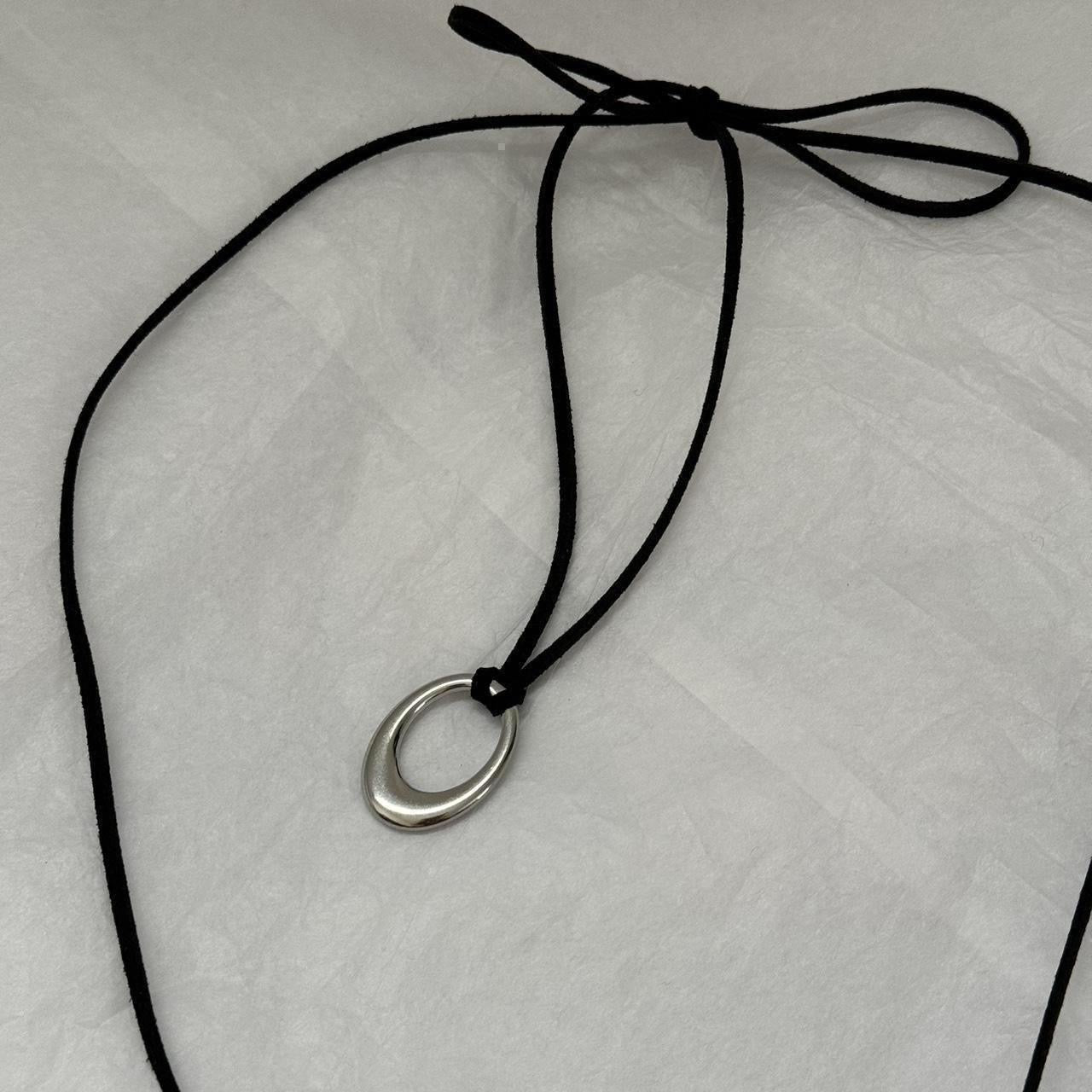 Chunky silver circular pendant corded necklace