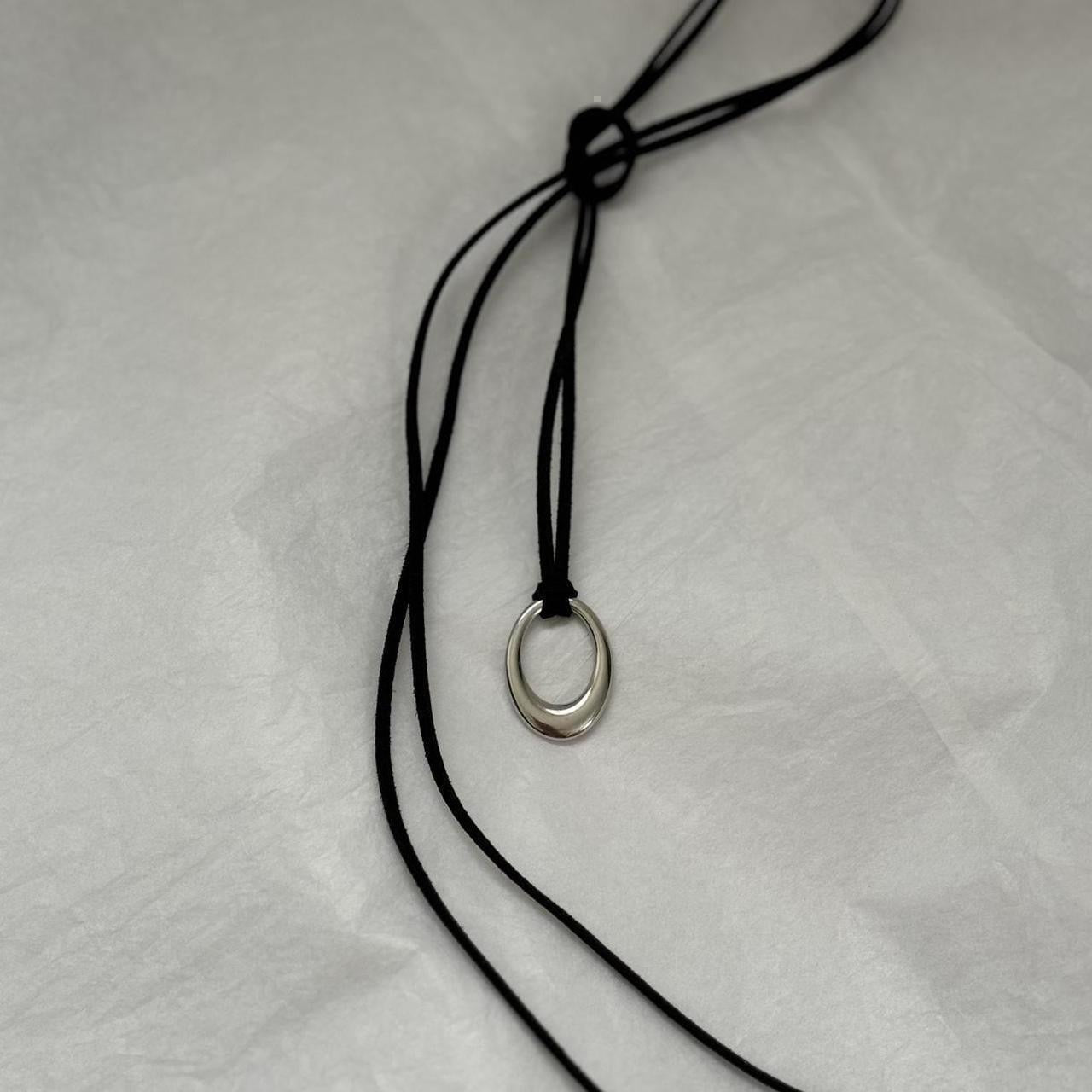 Chunky silver circular pendant corded necklace