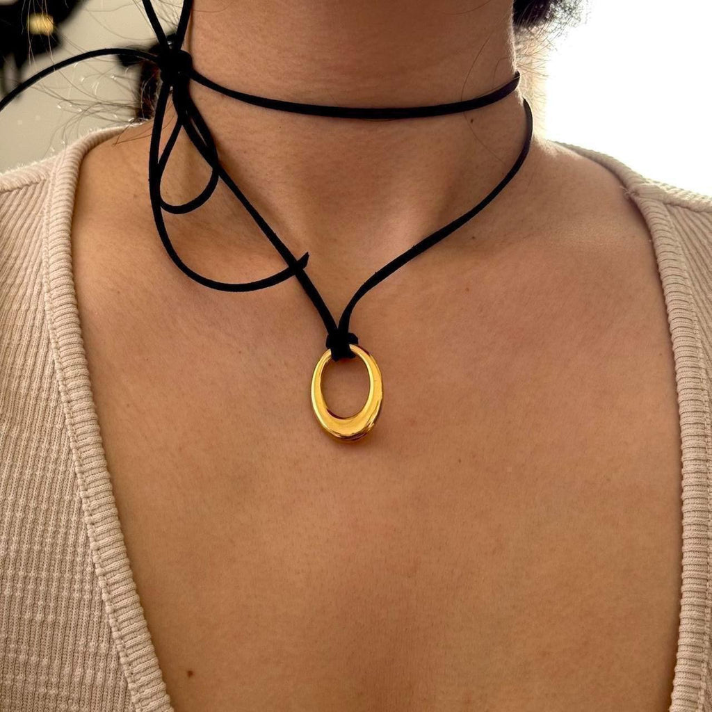 Chunky gold circular pendant corded necklace