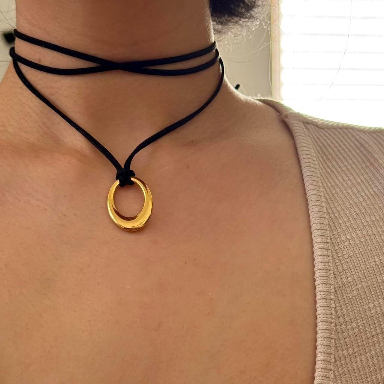Chunky gold circular pendant corded necklace