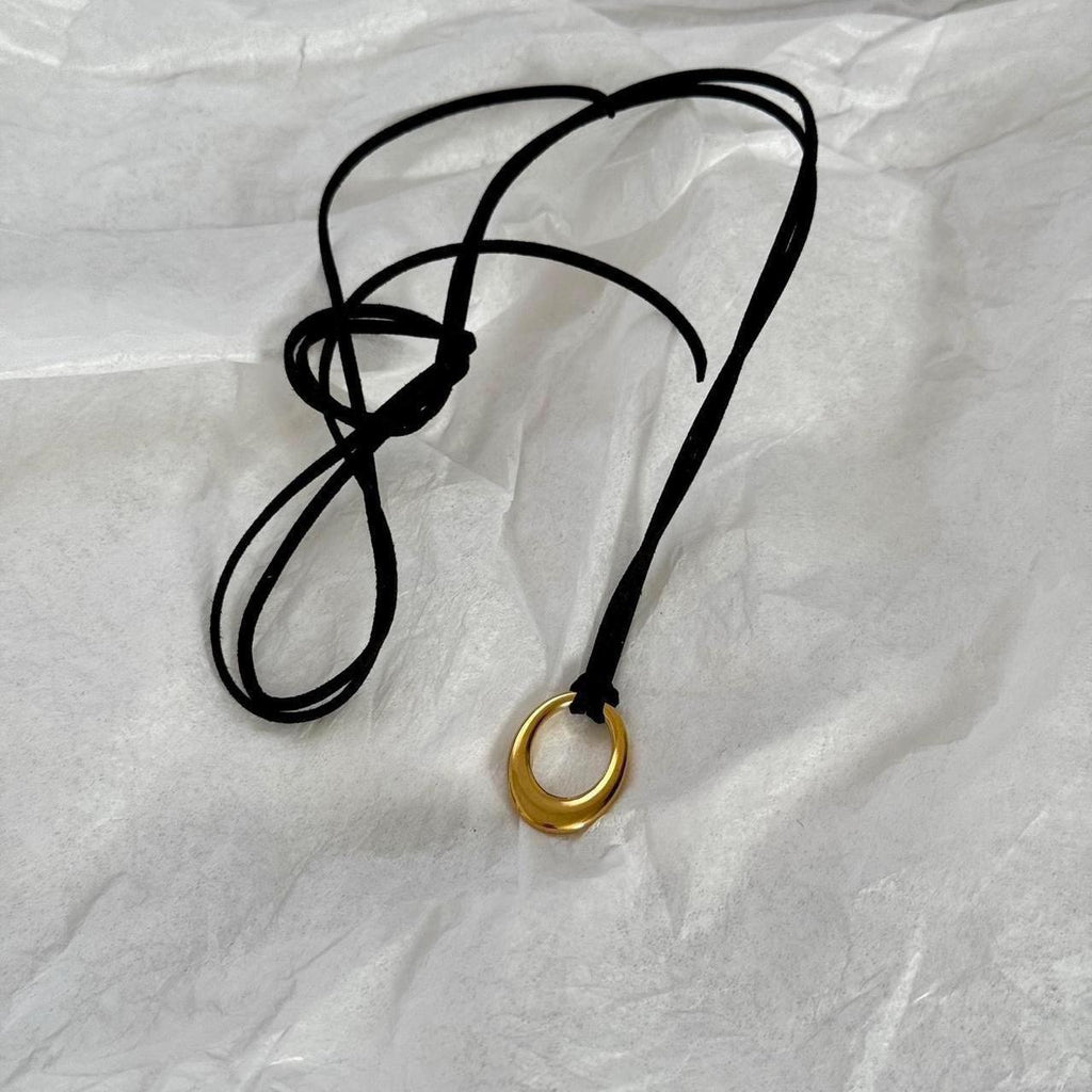 Chunky gold circular pendant corded necklace