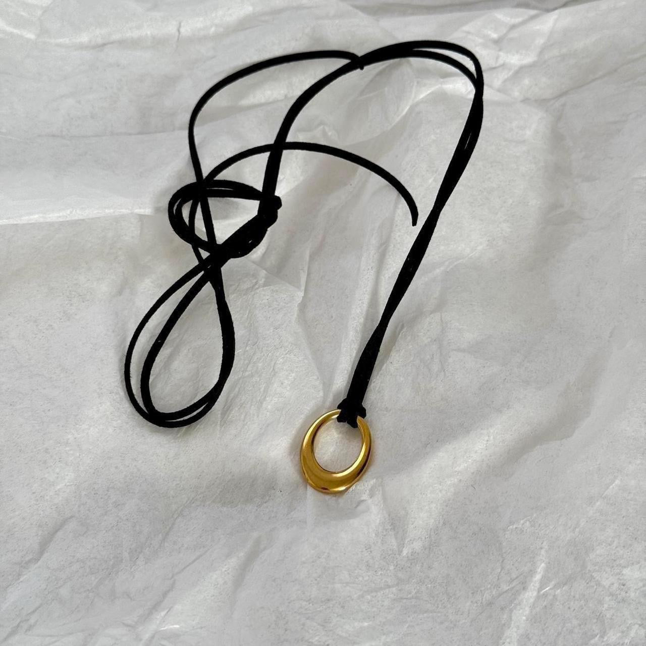 Chunky gold circular pendant corded necklace