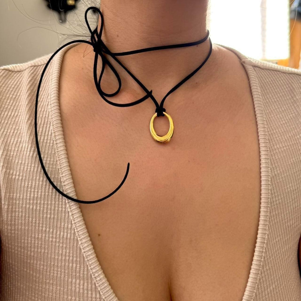 Chunky gold circular pendant corded necklace