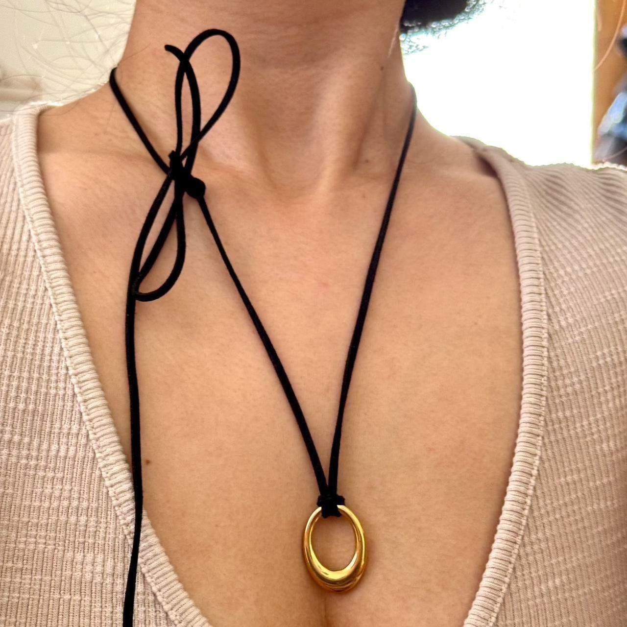 Chunky gold circular pendant corded necklace
