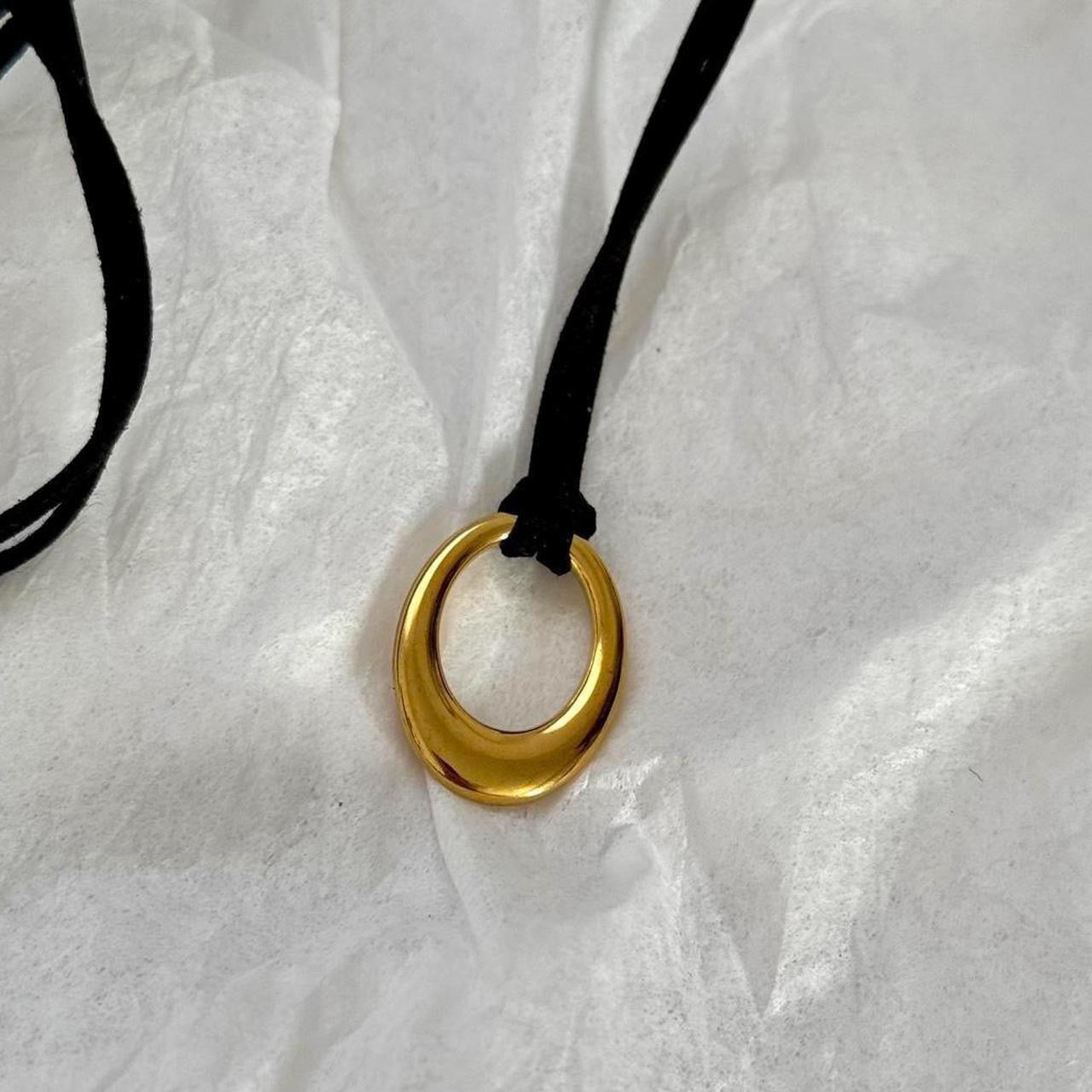Chunky gold circular pendant corded necklace