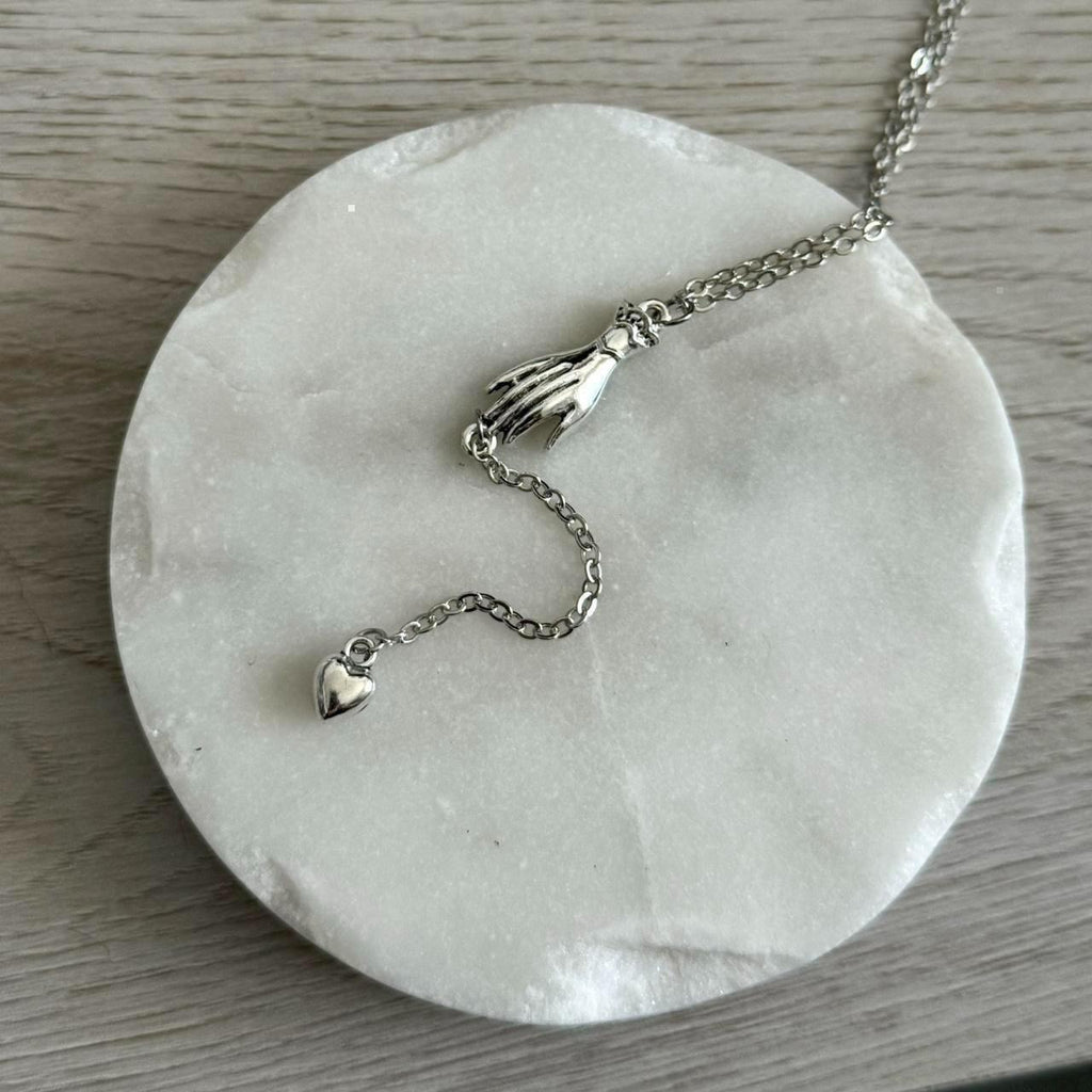 Hand with heart drop lariat necklace