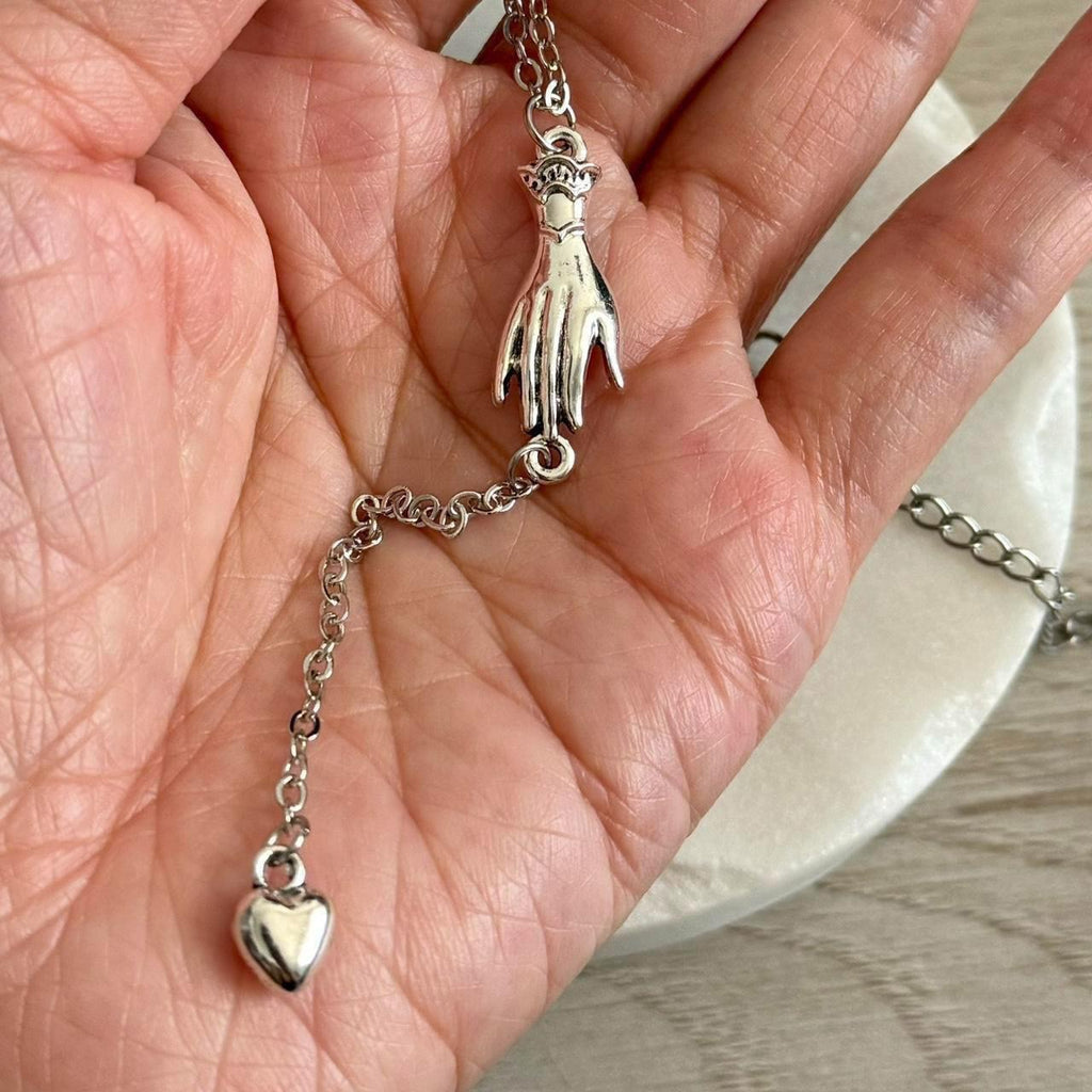 Hand with heart drop lariat necklace